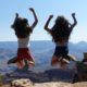 2 girls jumping at the grand canyon